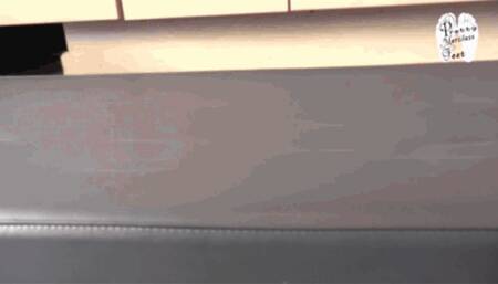 Leather upholstery and slaves hand under High Heels