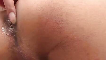 Curly-haired ladyboy in leopard dress strokes her shaved