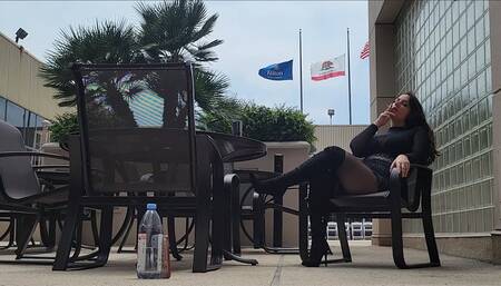 Liz River Smoking outdoors at DomCon Los Angeles Over the Knee Black Stiletto Boot, Black Stockings, Fringe Skirt, Sheer Top, Red Lip Stick, Long Dark Hair, Ignore, POV, BTS