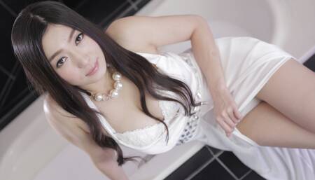 Pretty Asian girl flirts with the camera while giving a blowjob