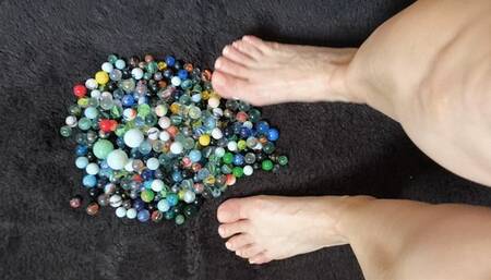 barefoot playing with glass balls