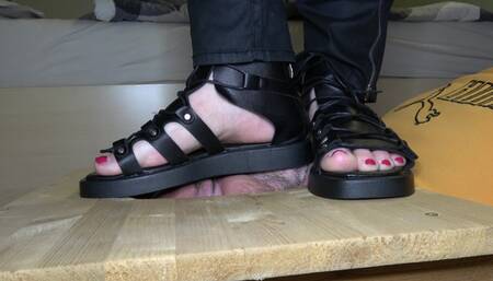 Stomping face in black sandals and barefoot (facebox)