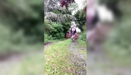 In a little floral skirt and fuchsia tie with stains in the garden for an evening