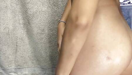 Stepdaughter oiling herself in the bathroom