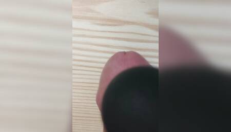 Squeezing dick on the table with magic wand