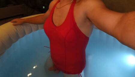 Ladyboy swimming in sexy red swimsuit