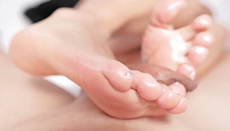 The bitch doesn't give a good footjob and ends up cumming