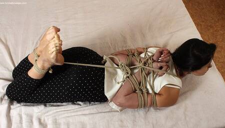 Edith: barefoot girl in white tank-top and black pants, hogtied with her hands in reverse prayer, wiggles on the floor (HD MOV)