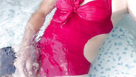 Tranny in hot Red one piece monokini swimming in pool