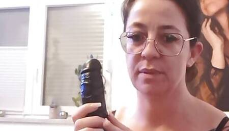 Tattooed brunette with glasses plays with her tampoo
