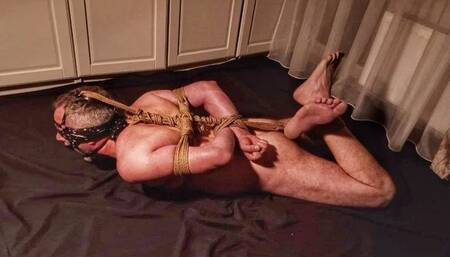 Naked male immobilized and hogtied