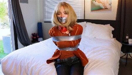 Blake LaVista as Ashley Graham, the daughter of the president taken captive and held tape bound and gagged!