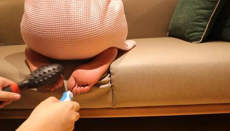 Female teacher’s bare feet were tickled on the sofa