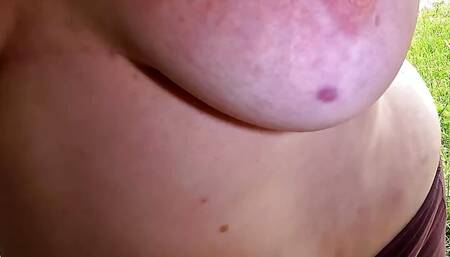 Slapping her naked tits at bus stop