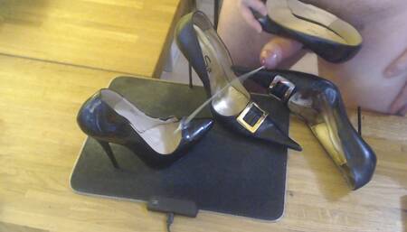 A guy masturbates with a high heel and cums on two pairs high heels