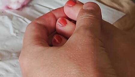 The wife does her nails topless and in a bikini, legs with nail polish, foots nails