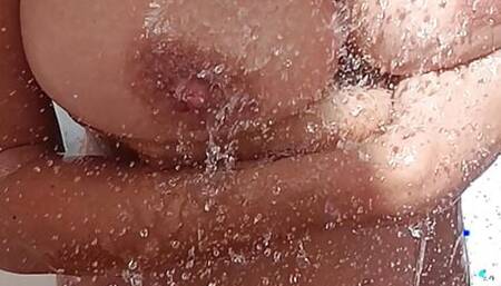 Hot sexy milf with tanned big tits takes a shower outdoors to cool off in the summer sun.