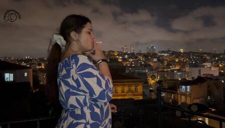 Smoking on the balcony with a city view