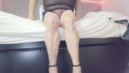 Tempest sits on bed with stripper heels
