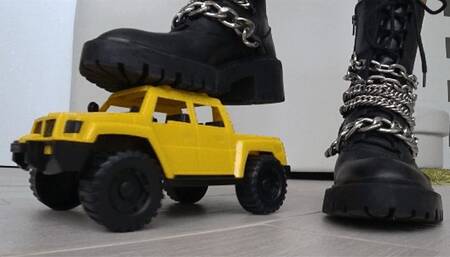 Crushed a toy car with black boots b