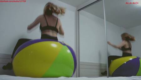 Alla does fitness and jumps high on a huge beach ball