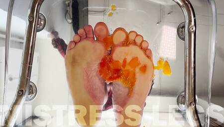 Squeezing cherry tomatoes with bare feet POV on your face