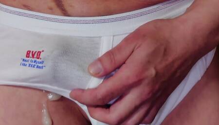 Squeeze your dick from the top of your white briefs and ejaculate as it is