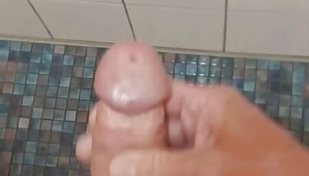 Wanked in the swimming pool under the shower