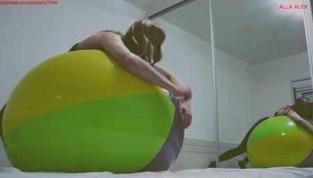 Alla deflates a large beach ball with a loud hissing sound