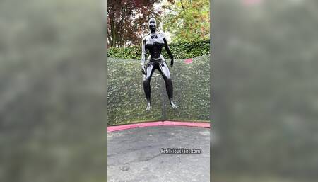 Miss Fetilicious jumping in latex catsuit