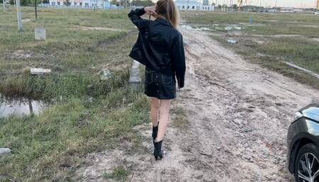 A girl in high-heeled boots walks through very deep mud, mud is poured into the boots and they get wet