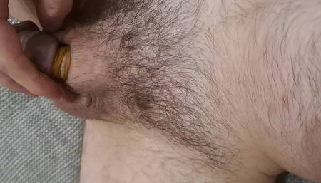 Banding the small flaccid cock for 40 minutes until it is numb