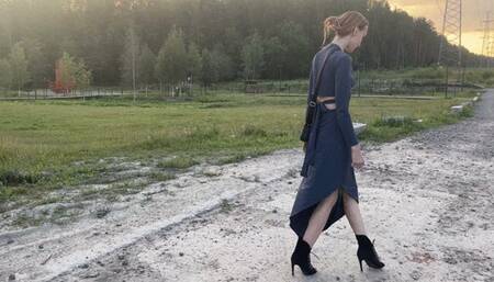 girl in high-heeled shoes is walking on a bad road and her heel turns up, she faults And she twists her leg a lot, it hurts her a lot