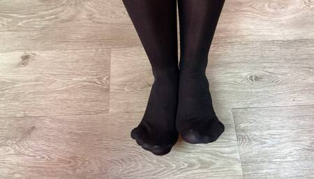 Girl in black stockings play with her boyfriend under table and gets a lot of cum on her feet after footjob