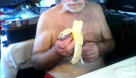 Coach Karl Seated Showing His Chest and Eating Banana[1505]
