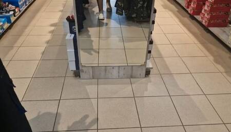 Dirty and sweaty feet try on high heels and sneakers in the big store 4K