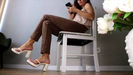 Toe tapping in brown pants and platform sandals