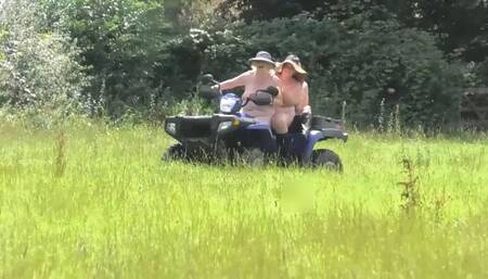 Crazy Naked Matures in floppy hats on a Quad bike