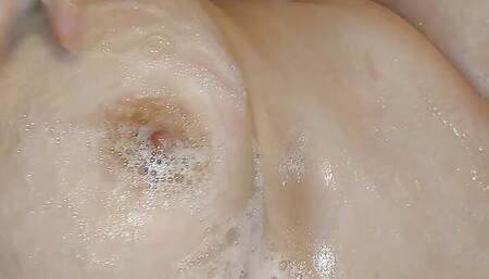 I press a big tit. I drip foam on the nipples. I stroke with my fingers and squeeze the breast. I want someone to lick my nipple