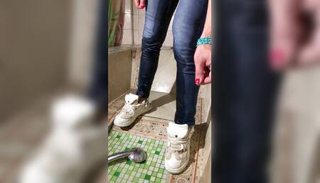 Wetting myself and soaking wet at the bathroonm in blue jeans, coral color t-shirt and white sneackers