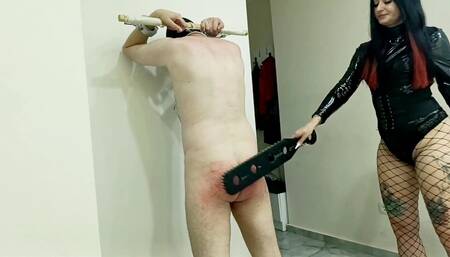 BDSM spanking. Dominatrix Nika spanked her slave's bare ass.