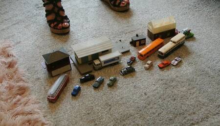 Back by popular demand GIANTESS Charn crushes small cars, buildings, buses in wedges closeup left view