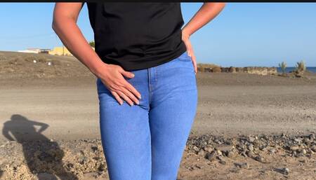 girk in jeans touching crotch