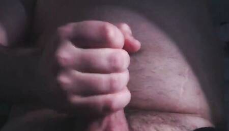 Chubby guy plays with his belly, masturbates and cums on his belly