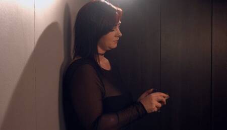 Smoking 2 cigarettes dressed up, stood up smoking