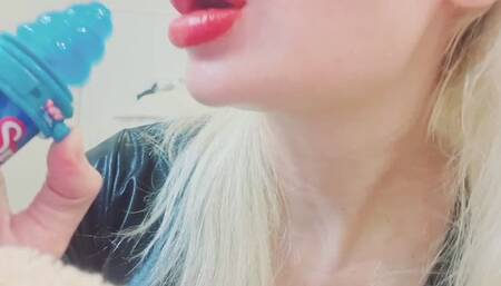 Sucking and licking blue lollipop