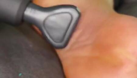 Ebony Girl Gives Her Feet a Massage with a Massage Gun