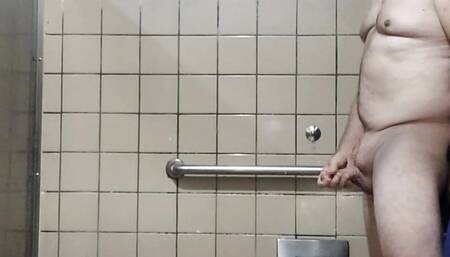 More old guy naked and masturbating in big men's room stall