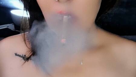 Smoking topless, savoring each drag