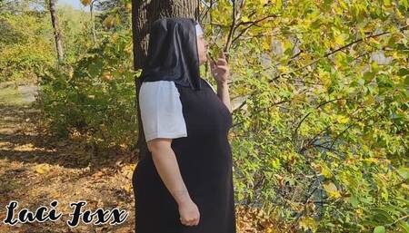 Unholy pregnant nun sneaks a cigarette